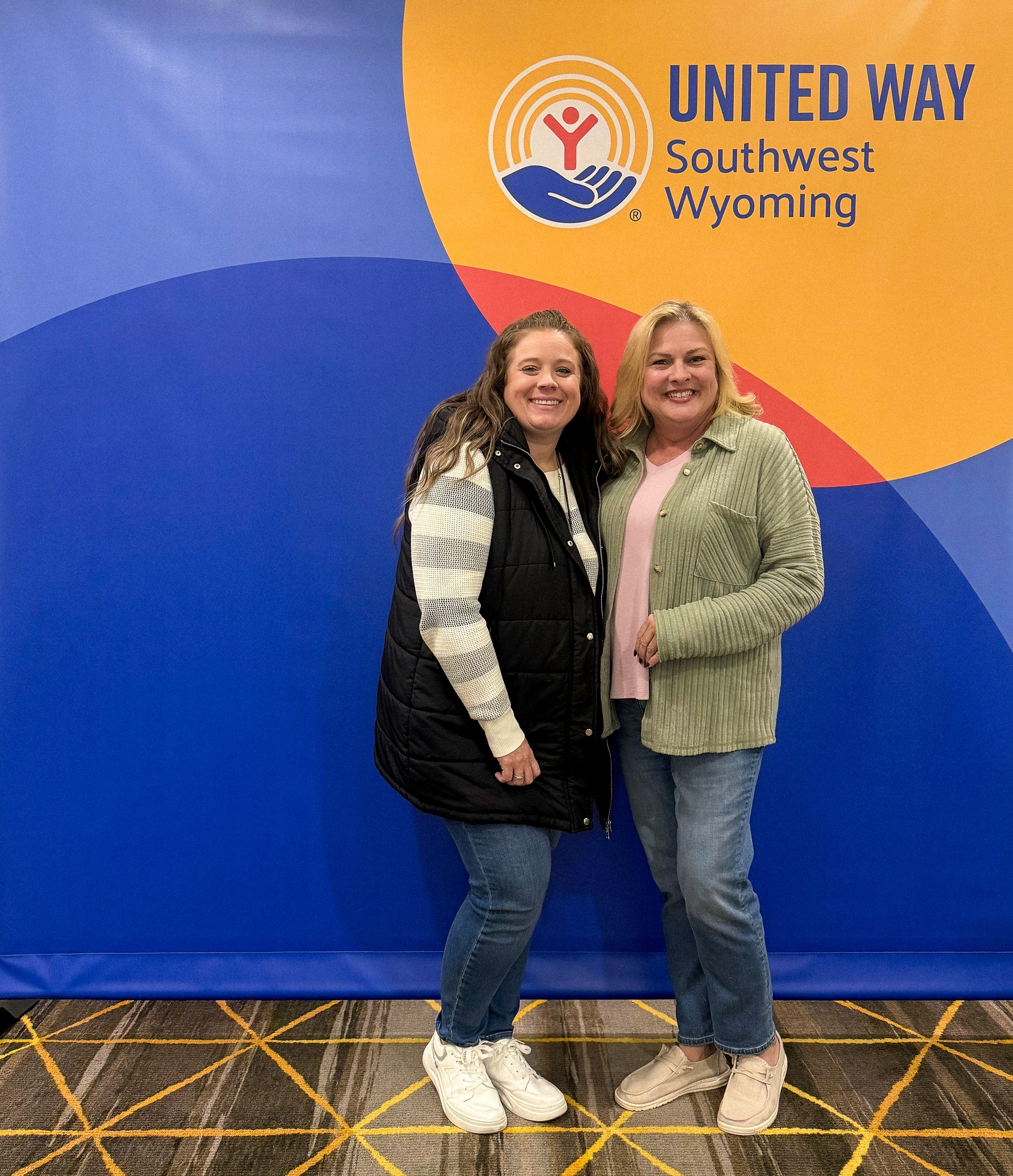 Simplot employees in front of United Way backdrop